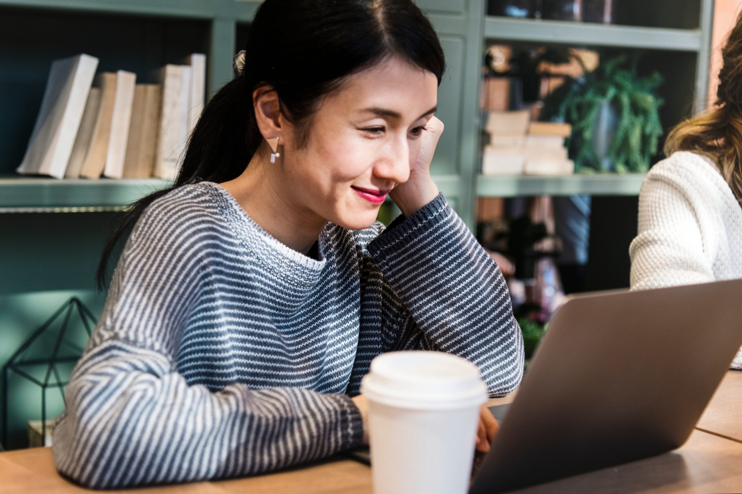 Battle SEO team member writing articles for clients on her computer for link building