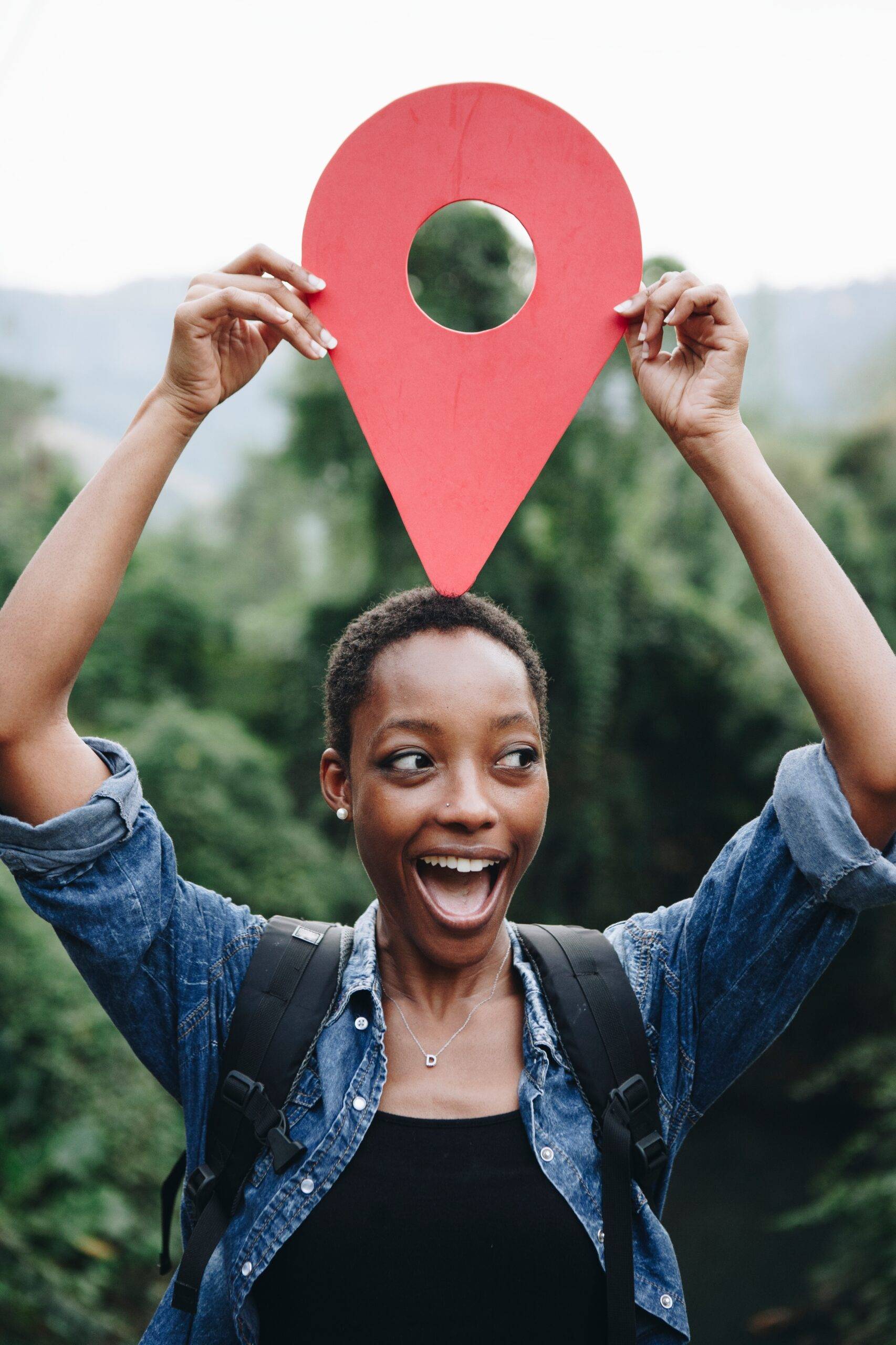 African American woman with a location pin symbol