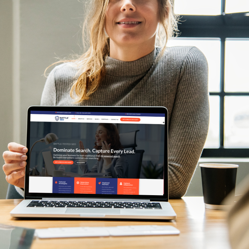 Woman holding a laptop displaying the Battle SEO website with the headline 'Dominate Search. Capture Every Lead.