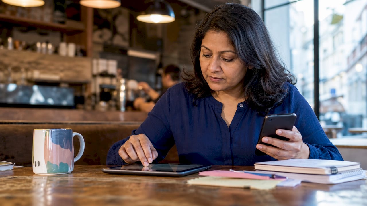 Local business owner checking proximity SEO data on devices